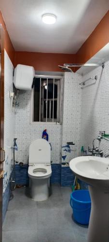 a bathroom with a toilet and a sink at indrapuri homestay in Darjeeling