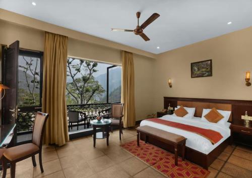 a hotel room with a bed and a balcony at Aureva Shaantam Resorts & Spa - Rishikesh in Rishīkesh