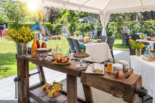 a picnic table with food on it in a park at Bed & Breakfast Tiffany in Domodossola