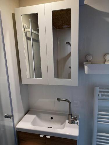 a bathroom with a sink and a mirror at Private Apartment Retreat in Breda