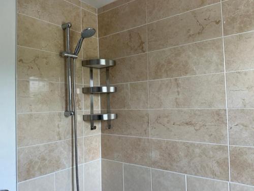 a shower in a bathroom with a glass door at Home away from away in Dartford