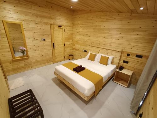 a bedroom with a bed in a wooden room at Wood Gold Ella in Ella