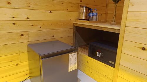 a small refrigerator in a kitchen with a counter at Wood Gold Ella in Ella