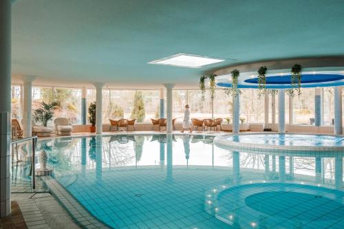 a large swimming pool in a building at Ruissalo Spa Hotel in Turku