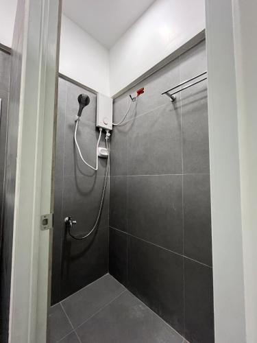 a shower stall in a bathroom with a shower at Wanderers Backpacker Condotel in Pusok