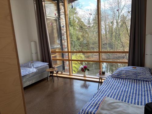 a bedroom with a bed and a large window at Gästewohnung Hardinghaus am Teich in Warendorf