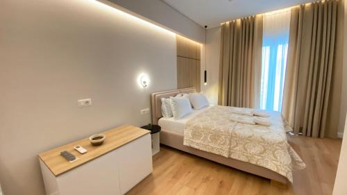 a hotel room with a bed and a table at Hotel Metali - City Centre in Sarandë