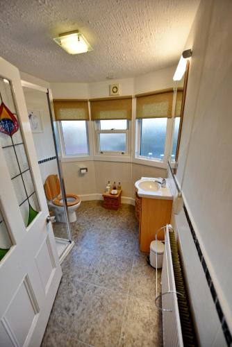 a bathroom with a sink and a toilet at Burnside Guest House in Ayr