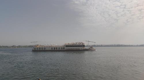 a large boat on a large body of water at Isis Hotel Nile View in Aswan