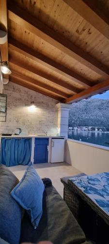 a room with a couch and a bed on a balcony at Adria House Dubrovnik by the sea in Zaton