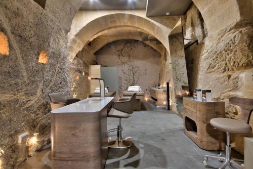 a bathroom with a sink in a stone wall at Palazzo Consiglia - IK Collection in Valletta