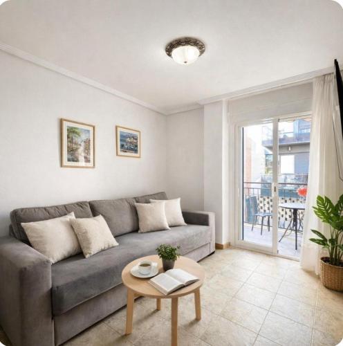 a living room with a couch and a table at Casa de Cludia in Santa Pola