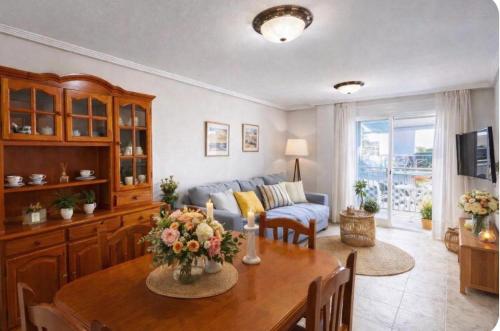 a living room with a table and a couch at Casa de Cludia in Santa Pola