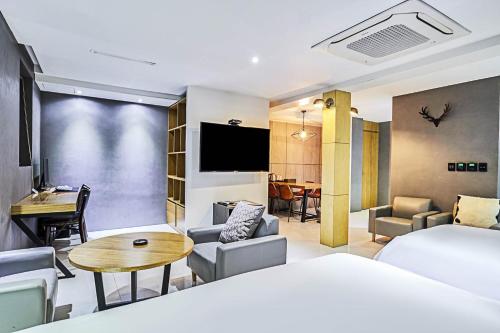 a hotel room with a bed and a table at 렉시호텔 in Seoul
