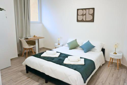 a bedroom with a large bed with towels on it at Casa Sangiorgio Srl in Treviglio
