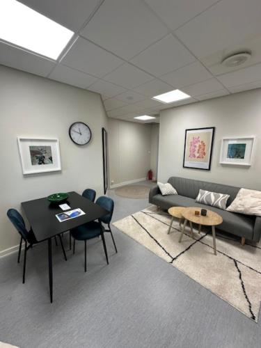 a living room with a couch and a table at Åsen Apartment, Stamsund in Stamsund