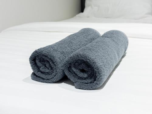 a gray towel sitting on a bathroom counter at On The Six Studios Pratamnak in Pattaya South