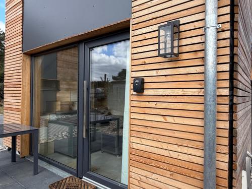 a house with a sliding glass door with a window at Tiny House 5 Seestern in Freest