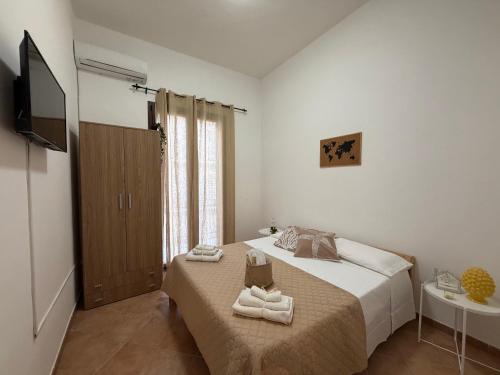 a bedroom with a bed with two towels on it at Sicilia Bedda Holiday Home in Cinisi
