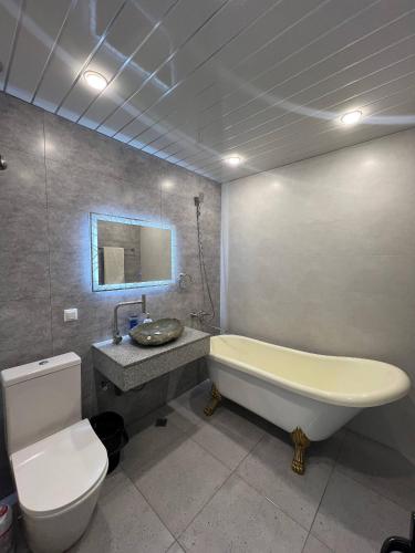 a bathroom with a tub and a toilet and a sink at Villa Loft in Balaovit