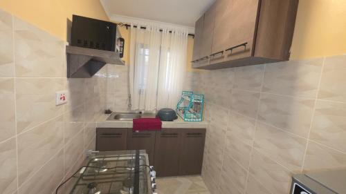 a small kitchen with a sink and a microwave at The Hidden Paradise in Mombasa