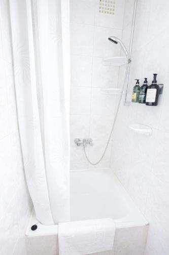 a bathroom with a shower with a shower curtain at Csopaki promenade in Csopak