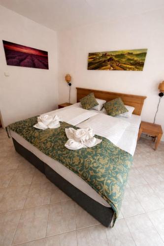 a bedroom with a bed with two towels on it at Csopaki promenade in Csopak