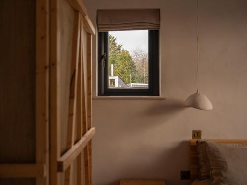 a window in a room with a bed and a lamp at Yarn - Milo Deluxe King Suite in Ballycastle