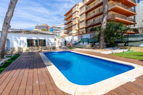 a swimming pool in front of a building at Villa Els Pins in El Arenal