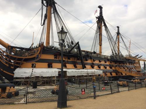 a large boat is sitting on display behind a fence at Gunwharf Quays Harbour Apartments in Portsmouth