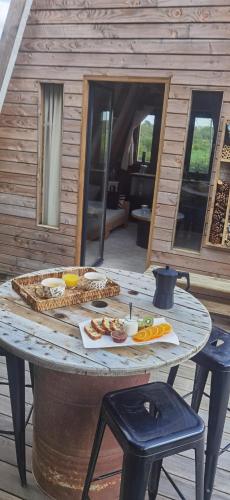 a table with food on top of it on a patio at La Kabanetik in La Tacherie
