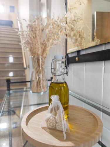 a bottle of olive oil on a table with a vase at Casa da Estação in Torre de Moncorvo