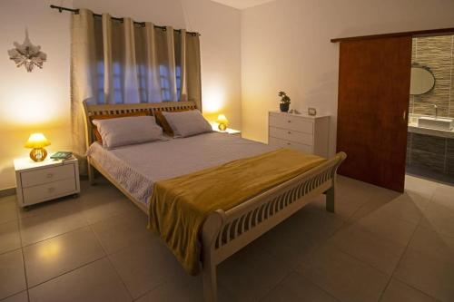 a bedroom with a large bed with a large window at Vila_da_Montanha in Gravatá