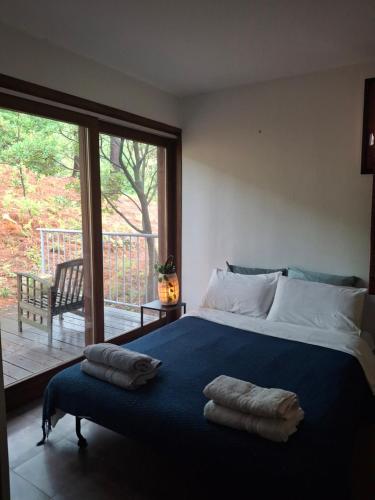 a bedroom with a large bed with two pillows on it at Maison zen in Laval-Pradel