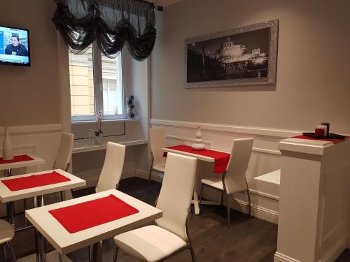 a dining room with white tables and red tables at Residenza Vatican Suite in Rome
