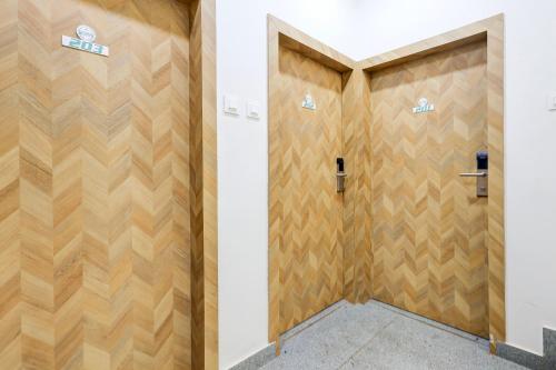 a pair of wooden doors in a building at FabHotel High Five - Nr Vagator Beach in Assagao