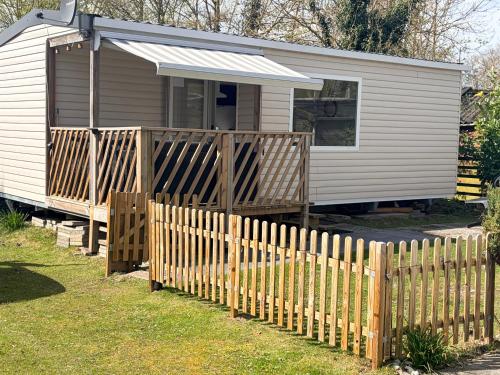 a wooden fence in front of a tiny house at Strand chalet Makkum in Makkum