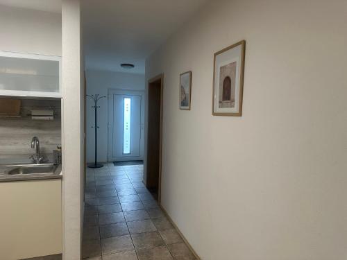 a hallway leading to a kitchen with a sink at Ferienwohnung am Nurburgring in Welcherath