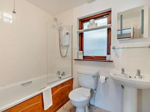 a white bathroom with a toilet and a sink at 1 Bed in Crieff oc-45288 in Saint Fillans