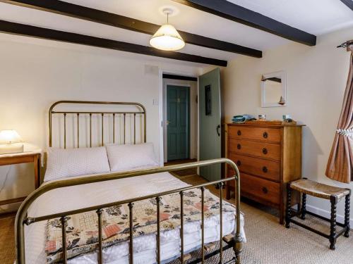 a bedroom with a bed and a dresser and a chair at 2 Bed in Montrose oc-an48m in Johnshaven