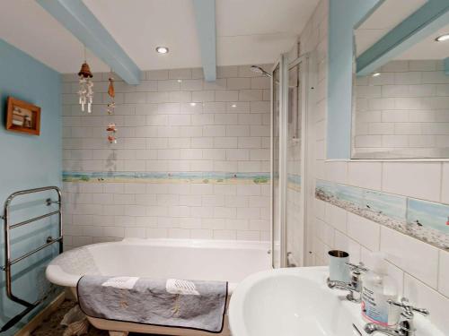 a bathroom with a tub and a sink at 2 Bed in Montrose oc-an48m in Johnshaven