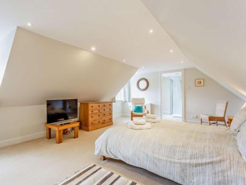 a bedroom with a large bed and a television at 3 Bed in Dingwall oc-ca388 in Cononbridge