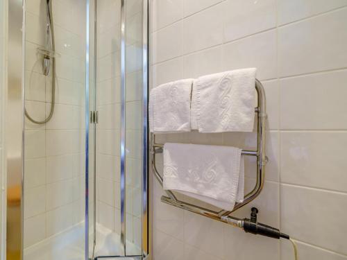 a bathroom with a shower and white towels at 3 Bed in Kendal oc-75564 in Crosthwaite
