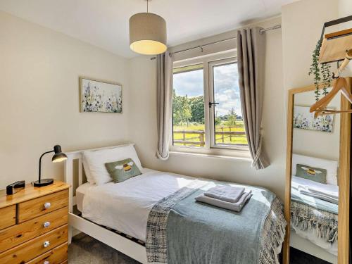 a small bedroom with a bed and a window at 2 Bed in Crewe oc-83192 in Audlem