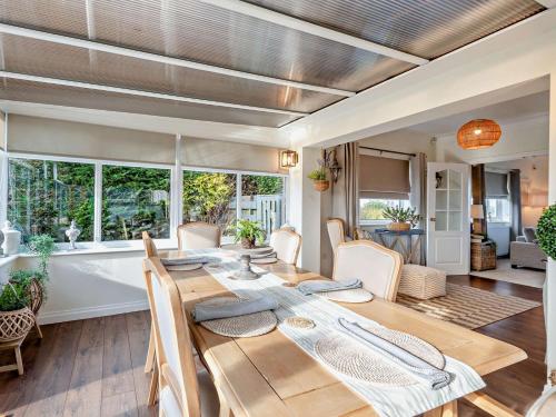 a dining room with a wooden table and chairs at 3 Bed in Maryport oc-82438 in Dearham