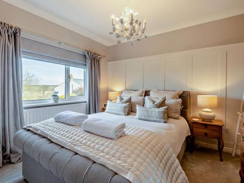 a bedroom with a large bed with a window at 3 Bed in Maryport oc-82438 in Dearham