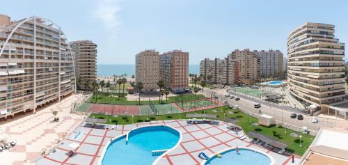 an aerial view of a city with two swimming pools at Cullera Playa Racó in Cullera