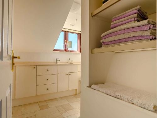 a bathroom with a sink and a pile of towels at 3 Bed in Penrith oc-89268 in Newton Reigny