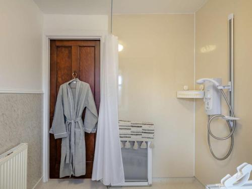 a robe hanging on a door in a bathroom at 3 Bed in Buckie oc-89824 in Buckie