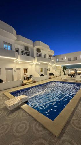 a large swimming pool in front of a building at Antika Hotel in Dahab